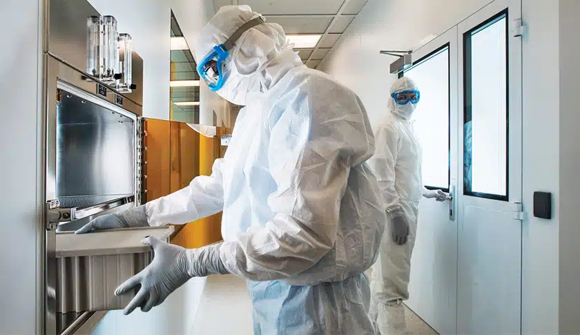 Cleanroom operatores in cleanroom with HMI's and boxes