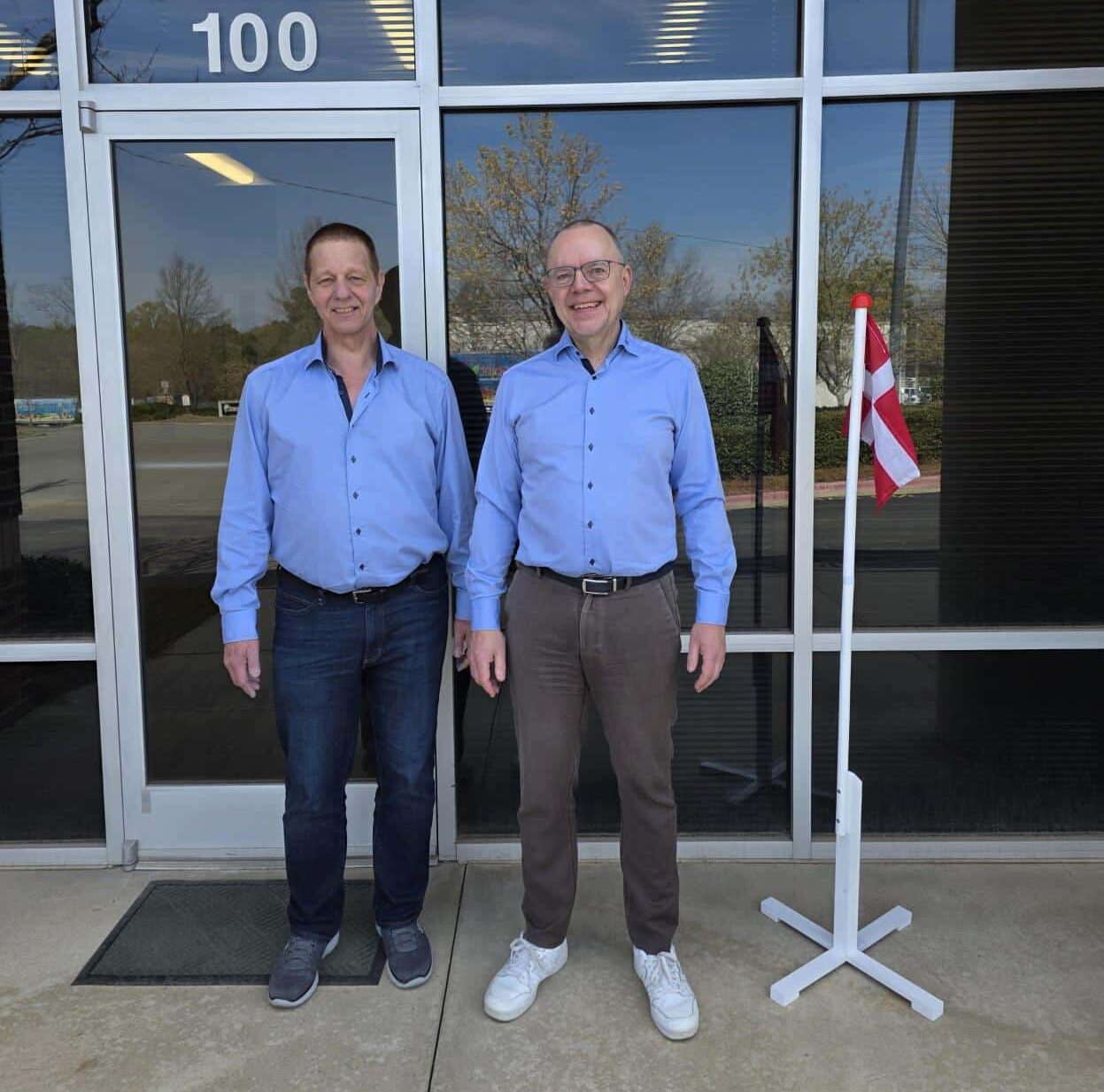 Niels Pedersen and Michael Asmussen from Blue Line standing in front of new building for Office in USA. Danish Flag.